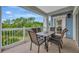 Outdoor patio with comfortable seating and views of lush green landscaping in the distance at 7652 Whisper Way # 301, Reunion, FL 34747