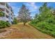 Building exterior surrounded by mature landscaping and lush green trees at 7652 Whisper Way # 301, Reunion, FL 34747