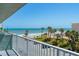 Beautiful ocean view from the balcony, showcasing palm trees and the sandy beach below on a sunny day at 800 N Atlantic Ave # 417, Daytona Beach, FL 32118