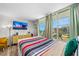 Bright bedroom with beach view, balcony access, and comfortable furnishings at 800 N Atlantic Ave # 417, Daytona Beach, FL 32118