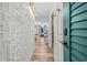Bright condo hallway featuring stylish wall decor and wood-look floors leading to an inviting living space with ocean views at 800 N Atlantic Ave # 417, Daytona Beach, FL 32118