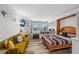 Inviting living space showcasing beds, sofa, and beach house decor at 800 N Atlantic Ave # 417, Daytona Beach, FL 32118
