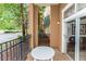 Private outdoor patio features a white table, black metal fence, and view of palm trees at 8100 Poinciana Blvd # 2109, Orlando, FL 32821