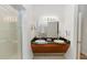 Bathroom featuring double sinks, a walk-in shower with glass doors, and white tile at 8100 Poinciana Blvd # 2109, Orlando, FL 32821
