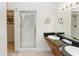 Bathroom featuring double sinks, a walk-in shower and a doorway leading to closet at 8100 Poinciana Blvd # 2109, Orlando, FL 32821
