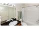 Bathroom featuring a dark granite countertop, modern lighting fixture, white tiled shower/tub, and a sleek, clean design at 8100 Poinciana Blvd # 2109, Orlando, FL 32821
