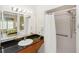 Bathroom featuring a sink with granite countertop and a shower stall with curtain and a large mirror at 8100 Poinciana Blvd # 2109, Orlando, FL 32821