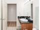 Bathroom featuring a single sink vanity with black countertop and an open doorway at 8100 Poinciana Blvd # 2109, Orlando, FL 32821