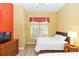 Comfortable bedroom with wood-look floors, closet space, natural light, and calming colors to enhance relaxation and rest at 8100 Poinciana Blvd # 2109, Orlando, FL 32821