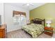 Bedroom featuring a bed with a tropical print comforter, wood-look flooring and a ceiling fan at 8100 Poinciana Blvd # 2109, Orlando, FL 32821