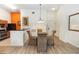 Well-lit dining space showcasing stylish flooring, an elegant chandelier, and providing seamless transition into kitchen at 8100 Poinciana Blvd # 2109, Orlando, FL 32821