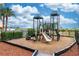 Community playground with slides, climbing structures, and wood chip ground cover at 8100 Poinciana Blvd # 2109, Orlando, FL 32821