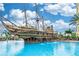 Resort style pool area featuring a pirate ship water feature and lounge chairs at 8100 Poinciana Blvd # 2109, Orlando, FL 32821