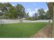 Lush backyard with green lawn and a white fence, offering privacy and space for outdoor enjoyment at 817 Benton Lake S Dr, Deland, FL 32724
