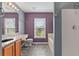 Bathroom featuring dual-sink vanity, soaking tub and large window at 817 Benton Lake S Dr, Deland, FL 32724