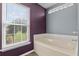 Bathroom featuring a soaking tub and large window at 817 Benton Lake S Dr, Deland, FL 32724