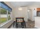 Bright dining area with a chandelier and large windows showcasing the backyard at 817 Benton Lake S Dr, Deland, FL 32724