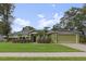 Charming one-story home featuring a well-manicured lawn, and attached two-car garage at 817 Benton Lake S Dr, Deland, FL 32724