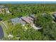 This aerial view highlights the home's location among lush trees and landscaped properties at 902 Wingate Trl, Port Orange, FL 32128