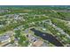 This aerial shows a neighborhood filled with mature trees, serene ponds, and well-maintained homes at 902 Wingate Trl, Port Orange, FL 32128