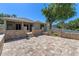 Expansive backyard patio with brick pavers, a charming outdoor fire pit, and a well-manicured lawn at 902 Wingate Trl, Port Orange, FL 32128