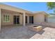 Spacious backyard patio with brick pavers, an outdoor fire pit, and beautiful views of the home's exterior at 902 Wingate Trl, Port Orange, FL 32128