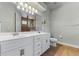 Bathroom featuring double sinks with white cabinets and granite countertops at 902 Wingate Trl, Port Orange, FL 32128