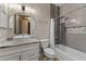 Modern bathroom featuring gray tiled walls, a sleek vanity with vessel sink, and a shower-tub combo at 902 Wingate Trl, Port Orange, FL 32128
