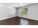 Bedroom with wood floors, a ceiling fan, and a window with plantation blinds at 902 Wingate Trl, Port Orange, FL 32128