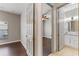 Bright bedroom with hardwood floors adjacent to updated bathroom, providing a functional space at 902 Wingate Trl, Port Orange, FL 32128