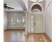 Inviting foyer with tile flooring, a soaring arched window, and a decorative column showcasing the home's architecture at 902 Wingate Trl, Port Orange, FL 32128