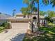 Charming single-story home with a well-manicured lawn and mature landscaping, including palm trees at 902 Wingate Trl, Port Orange, FL 32128