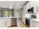 Bright kitchen featuring white cabinets, stainless steel appliances, and quartz countertops at 902 Wingate Trl, Port Orange, FL 32128