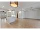 Spacious open-concept living area with tile floors and a glimpse of the kitchen and archways at 902 Wingate Trl, Port Orange, FL 32128