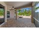 Covered patio with brick pavers and a fire pit, overlooking a serene view of the surrounding landscape at 902 Wingate Trl, Port Orange, FL 32128