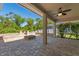 Covered patio with brick pavers, a fire pit, and lush greenery, ideal for outdoor entertaining at 902 Wingate Trl, Port Orange, FL 32128