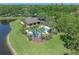 A beautiful community pool area is nestled alongside a serene lake, offering an inviting view at 902 Wingate Trl, Port Orange, FL 32128