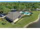 This aerial view captures the community pool and neighboring lake at 902 Wingate Trl, Port Orange, FL 32128