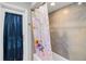 Updated bathroom with shower/tub combo featuring vibrant flower-themed shower curtain at 9338 Palm Tree Dr, Windermere, FL 34786