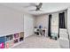 Bedroom with a ceiling fan, double door closet, and multiple storage shelves at 9338 Palm Tree Dr, Windermere, FL 34786