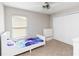 Bedroom with carpet, closet, ceiling fan, and large window letting in plenty of natural light at 9338 Palm Tree Dr, Windermere, FL 34786