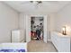 Bright bedroom boasts a ceiling fan, closet with storage, and white dressers for ample storage space at 9338 Palm Tree Dr, Windermere, FL 34786