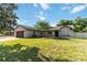 Charming single-story home with well-maintained lawn, mature landscaping, and inviting curb appeal at 9338 Palm Tree Dr, Windermere, FL 34786