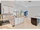 Open kitchen with granite counters, stainless appliances, and views into the living area at 9338 Palm Tree Dr, Windermere, FL 34786