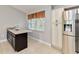 Kitchen area with stainless steel refrigerator, ample cabinet space, and window view at 9338 Palm Tree Dr, Windermere, FL 34786