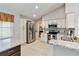 Spacious kitchen featuring stainless steel appliances, white cabinets, and granite countertops at 9338 Palm Tree Dr, Windermere, FL 34786