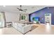 Stylish living room with a vaulted ceiling, a comfortable sofa, and a large window for natural light at 9338 Palm Tree Dr, Windermere, FL 34786