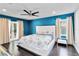 Stylish main bedroom with blue accent wall, ceiling fan, and access to a private balcony at 9338 Palm Tree Dr, Windermere, FL 34786