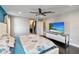 The main bedroom boasts a ceiling fan, television, and ensuite bathroom for a luxurious experience at 9338 Palm Tree Dr, Windermere, FL 34786
