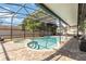 Inviting screened-in pool area with a spa, a paved patio, and comfortable seating, perfect for relaxation at 9338 Palm Tree Dr, Windermere, FL 34786